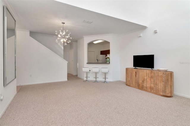 2173 Tuscany Trce Unit 8, Palm Harbor, FL 34683 - unfurnished living room featuring carpet floors, stairway, a chandelier, and baseboards