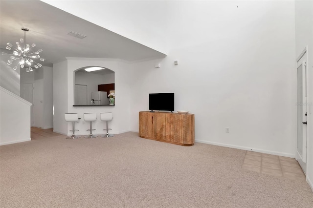 2173 Tuscany Trce Unit 8, Palm Harbor, FL 34683 - unfurnished living room featuring carpet floors, a chandelier, and baseboards