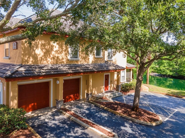 2173 Tuscany Trce Unit 8, Palm Harbor, FL 34683 - view of front facade with stucco siding, driveway, and an attached garage