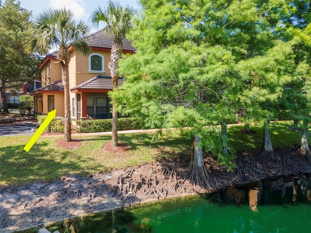 2173 Tuscany Trce Unit 8, Palm Harbor, FL 34683 - rear view of house with stucco siding and a tiled roof
