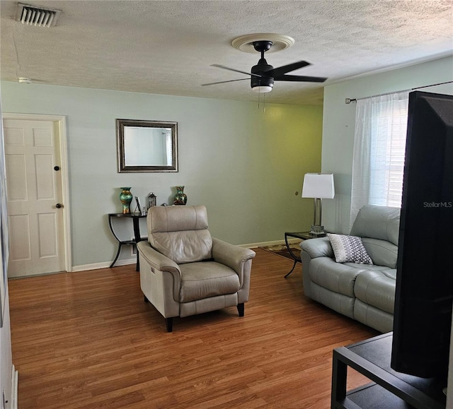 603 Southwood Cv, Brandon, FL 33511 - living area with a textured ceiling, wood finished floors, ceiling fan, and baseboards
