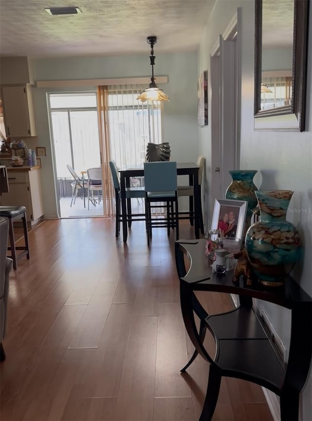 603 Southwood Cv, Brandon, FL 33511 - dining room featuring light wood-style flooring and a textured ceiling