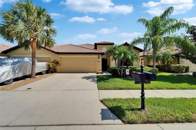 5646 Sunset Falls Dr, Apollo Beach, FL 33572 - mediterranean / spanish house with an attached garage, driveway, stucco siding, and a tile roof
