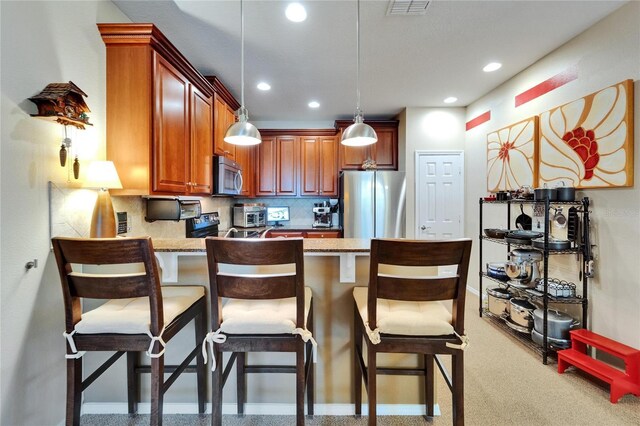 5646 Sunset Falls Dr, Apollo Beach, FL 33572 - kitchen with stainless steel appliances, a peninsula, decorative light fixtures, recessed lighting, and tasteful backsplash