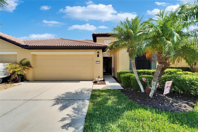 5646 Sunset Falls Dr, Apollo Beach, FL 33572 - mediterranean / spanish-style home with concrete driveway, stucco siding, and an attached garage