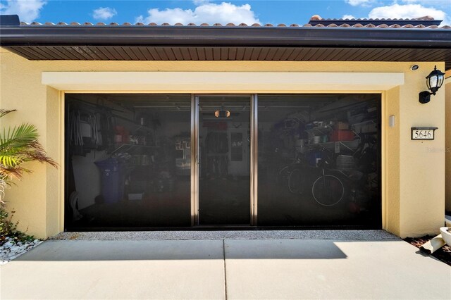 5646 Sunset Falls Dr, Apollo Beach, FL 33572 - view of exterior entry with stucco siding and a garage