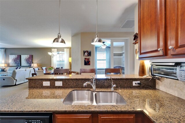 5646 Sunset Falls Dr, Apollo Beach, FL 33572 - kitchen featuring a sink, open floor plan, dishwashing machine, a ceiling fan, and light stone counters