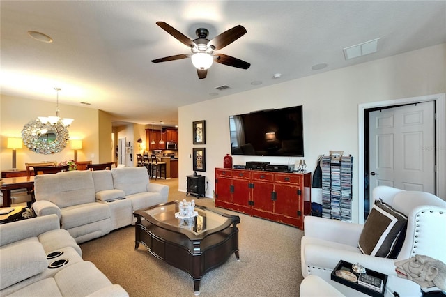 5646 Sunset Falls Dr, Apollo Beach, FL 33572 - carpeted living room with a chandelier and ceiling fan