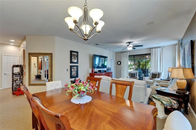 5646 Sunset Falls Dr, Apollo Beach, FL 33572 - dining space featuring a chandelier, light colored carpet, and a ceiling fan