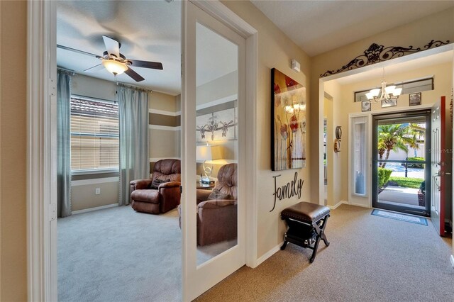 5646 Sunset Falls Dr, Apollo Beach, FL 33572 - entrance foyer with carpet flooring, a chandelier, a ceiling fan, and baseboards
