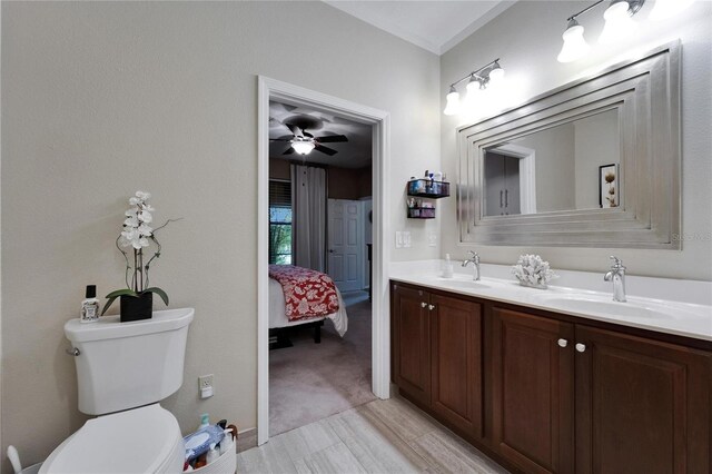 5646 Sunset Falls Dr, Apollo Beach, FL 33572 - ensuite bathroom with toilet, ceiling fan, double vanity, and wood finished floors