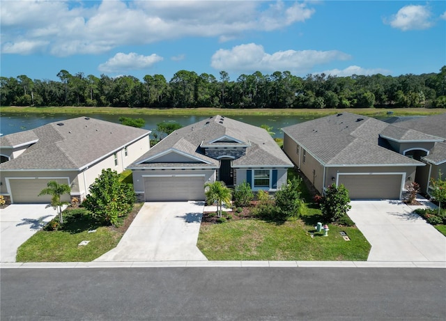 2247 Midnight Pearl Dr, Sarasota, FL 34240 - view of front of property with driveway, an attached garage, and a water view