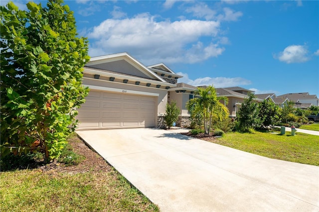 2247 Midnight Pearl Dr, Sarasota, FL 34240 - view of front of house with stucco siding, concrete driveway, an attached garage, stone siding, and a front lawn