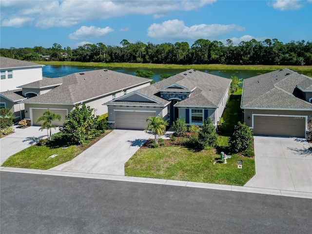 2247 Midnight Pearl Dr, Sarasota, FL 34240 - view of front of house with concrete driveway, an attached garage, a water view, a front lawn, and view of wooded area