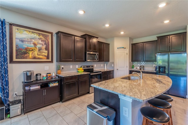 2247 Midnight Pearl Dr, Sarasota, FL 34240 - kitchen with appliances with stainless steel finishes, a sink, tasteful backsplash, light stone countertops, and recessed lighting