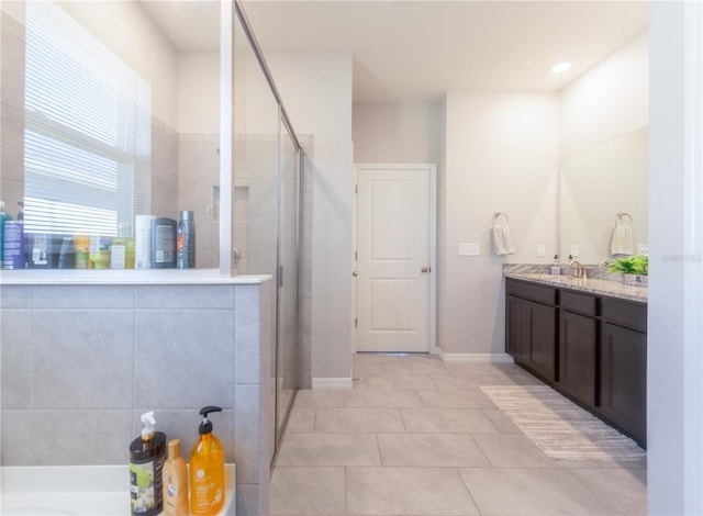 2247 Midnight Pearl Dr, Sarasota, FL 34240 - bathroom featuring vanity, a shower stall, tile patterned floors, baseboards, and a garden tub
