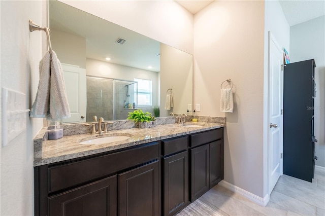 2247 Midnight Pearl Dr, Sarasota, FL 34240 - full bathroom with a stall shower, double vanity, tile patterned floors, and baseboards