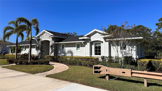 2247 Midnight Pearl Dr, Sarasota, FL 34240 - single story home featuring stucco siding, a front yard, and stone siding