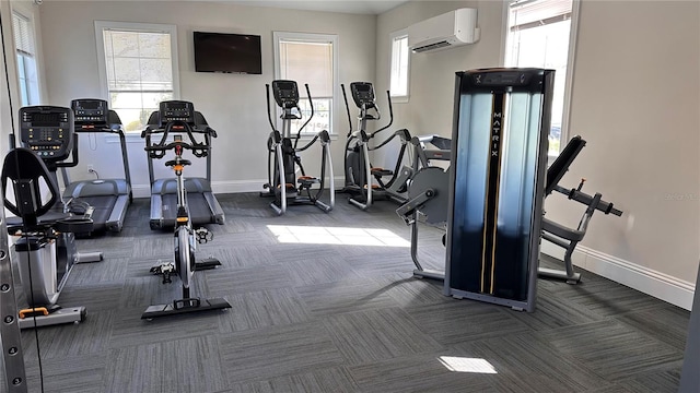 2247 Midnight Pearl Dr, Sarasota, FL 34240 - exercise room featuring dark carpet, baseboards, a wall mounted air conditioner, and healthy amount of natural light