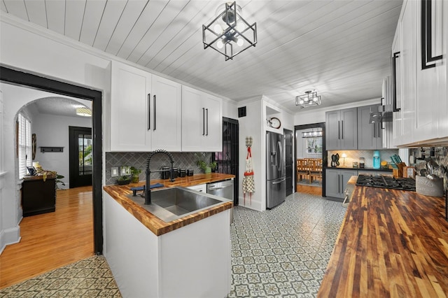6251 4th Ave S, Saint Petersburg, FL 33707 - kitchen featuring butcher block countertops, appliances with stainless steel finishes, a chandelier, and a sink