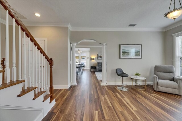 110 Aberdeen Pond Dr, Apollo Beach, FL 33572 - entryway featuring decorative columns, arched walkways, healthy amount of natural light, wood finished floors, and ornamental molding