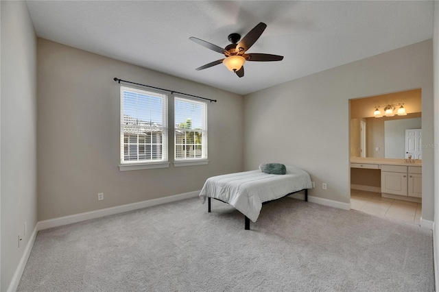 110 Aberdeen Pond Dr, Apollo Beach, FL 33572 - bedroom with light carpet, baseboards, a sink, ensuite bathroom, and a ceiling fan