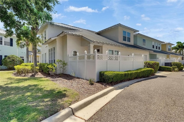 110 Aberdeen Pond Dr, Apollo Beach, FL 33572 - view of property exterior with stucco siding, metal roof, and a standing seam roof