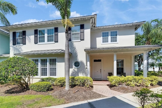 110 Aberdeen Pond Dr, Apollo Beach, FL 33572 - view of front of house featuring stucco siding, metal roof, and a standing seam roof