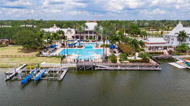 110 Aberdeen Pond Dr, Apollo Beach, FL 33572 - bird's eye view of a pool, a large body of water, and a tree filled landscape