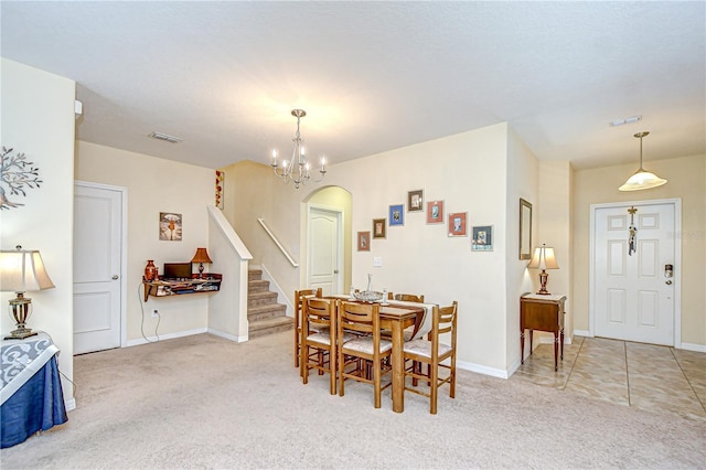 2723 Garden Falls Dr, Brandon, FL 33511 - dining area with light colored carpet, a chandelier, stairway, and baseboards