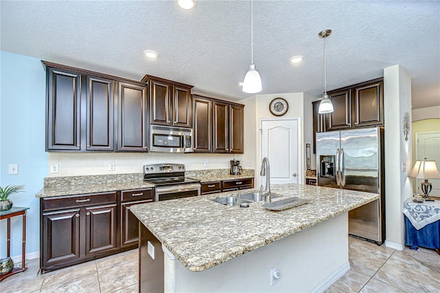 2723 Garden Falls Dr, Brandon, FL 33511 - kitchen featuring stainless steel appliances, a sink, dark brown cabinets, light stone countertops, and a textured ceiling