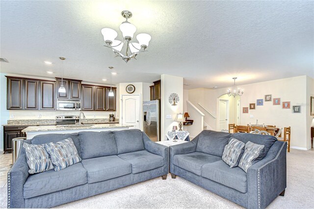 2723 Garden Falls Dr, Brandon, FL 33511 - living area featuring a chandelier, stairway, a textured ceiling, light carpet, and recessed lighting