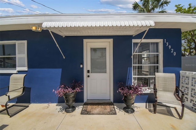 13920 Berkowitz Ave, Hudson, FL 34667 - property entrance featuring stucco siding