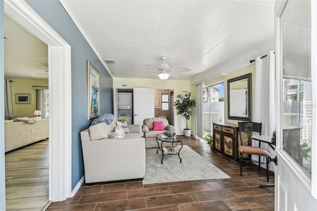 13920 Berkowitz Ave, Hudson, FL 34667 - living room with a ceiling fan, healthy amount of natural light, wood tiled floors, and baseboards