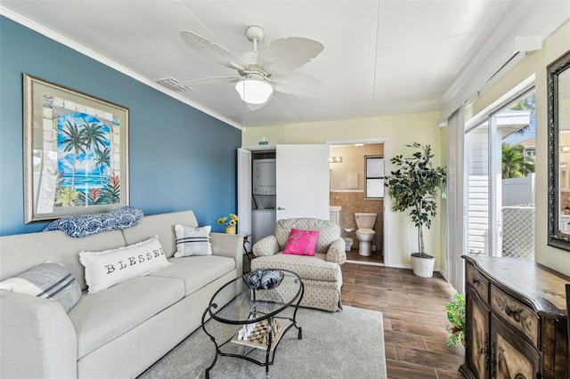 13920 Berkowitz Ave, Hudson, FL 34667 - living room featuring wood finished floors, a ceiling fan, crown molding, and baseboards