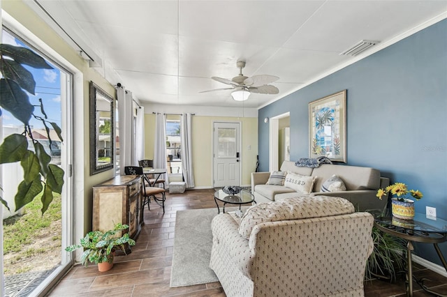13920 Berkowitz Ave, Hudson, FL 34667 - living area with wood finished floors, a ceiling fan, baseboards, and crown molding