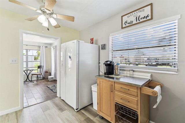 13920 Berkowitz Ave, Hudson, FL 34667 - kitchen with white refrigerator with ice dispenser, light wood finished floors, an office area, a ceiling fan, and baseboards