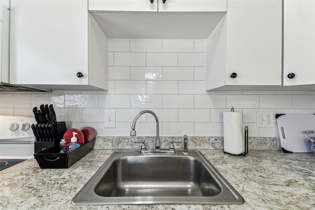 13920 Berkowitz Ave, Hudson, FL 34667 - kitchen with a sink, light countertops, white cabinetry, backsplash, and white electric range