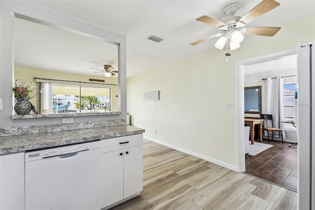 13920 Berkowitz Ave, Hudson, FL 34667 - kitchen featuring white dishwasher, ceiling fan, wood finished floors, and plenty of natural light