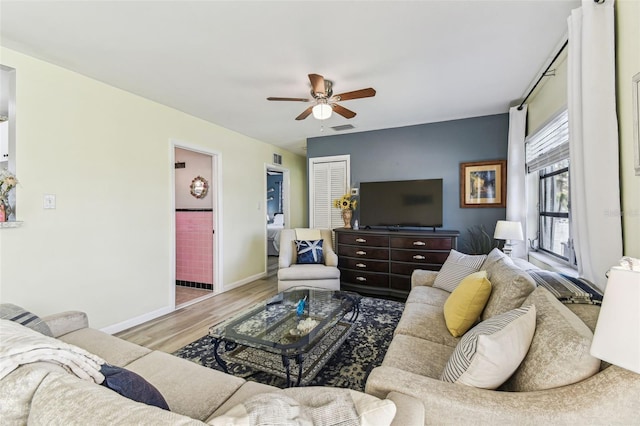13920 Berkowitz Ave, Hudson, FL 34667 - living room featuring a ceiling fan, wood finished floors, and baseboards