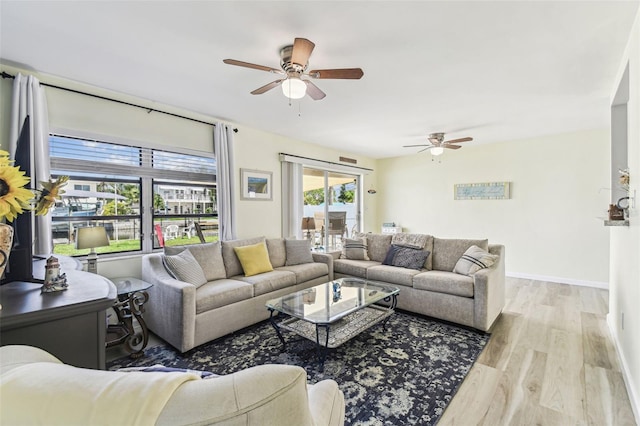 13920 Berkowitz Ave, Hudson, FL 34667 - living area featuring a ceiling fan, wood finished floors, and baseboards