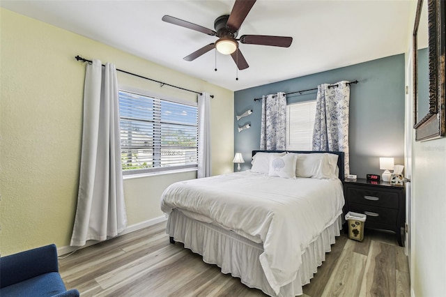 13920 Berkowitz Ave, Hudson, FL 34667 - bedroom featuring wood finished floors, baseboards, and ceiling fan