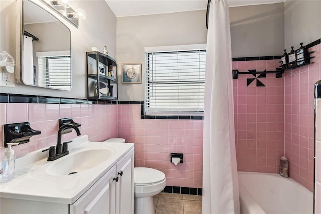 13920 Berkowitz Ave, Hudson, FL 34667 - full bath featuring tile walls, tile patterned flooring, toilet, healthy amount of natural light, and a wainscoted wall