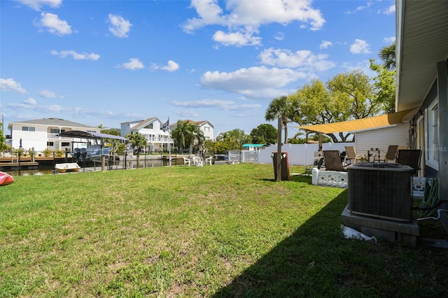 13920 Berkowitz Ave, Hudson, FL 34667 - view of yard featuring central AC unit, a boat dock, a residential view, and a water view