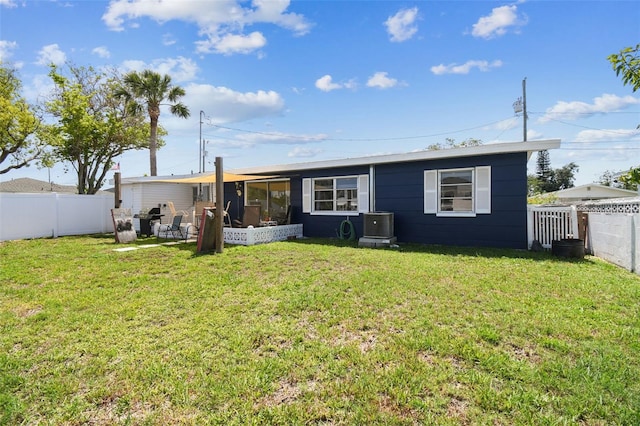 13920 Berkowitz Ave, Hudson, FL 34667 - back of house with central AC and a sunroom