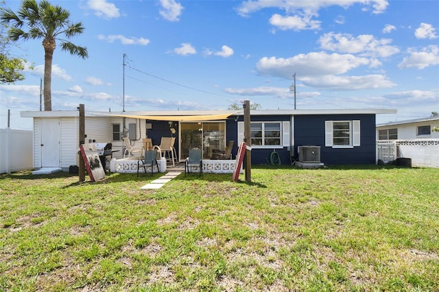 13920 Berkowitz Ave, Hudson, FL 34667 - rear view of house featuring central AC and a sunroom