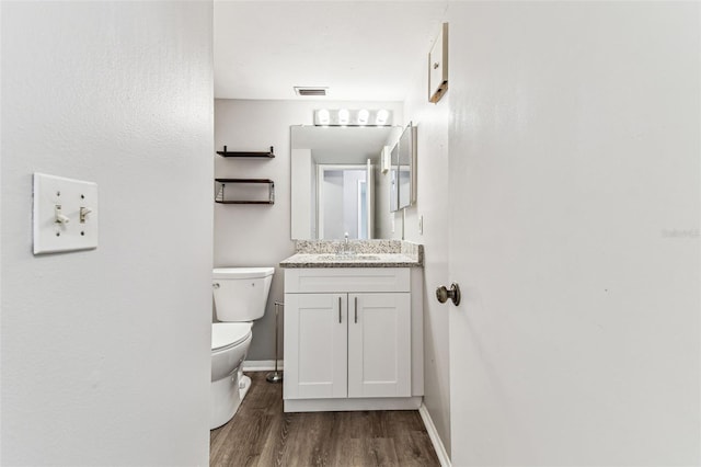 39650 US Highway 19 N Unit 143, Tarpon Springs, FL 34689 - half bathroom with wood finished floors, toilet, baseboards, and vanity