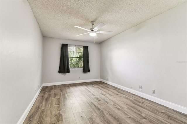 39650 US Highway 19 N Unit 143, Tarpon Springs, FL 34689 - spare room featuring wood finished floors, ceiling fan, a textured ceiling, and baseboards