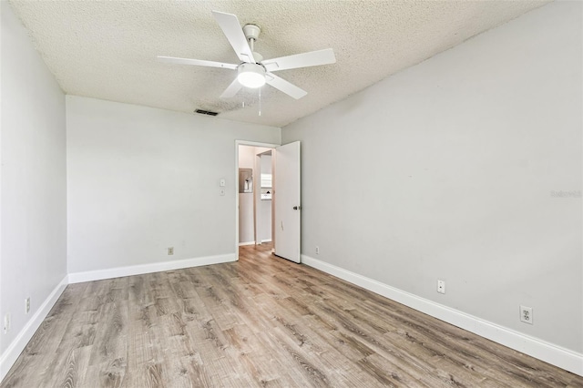 39650 US Highway 19 N Unit 143, Tarpon Springs, FL 34689 - unfurnished bedroom with wood finished floors, a textured ceiling, baseboards, and a ceiling fan