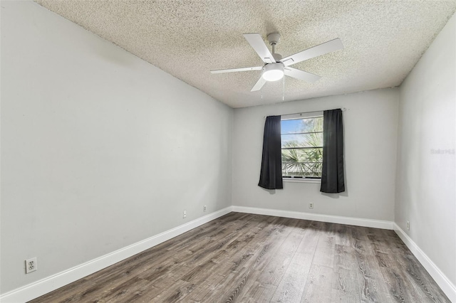 39650 US Highway 19 N Unit 143, Tarpon Springs, FL 34689 - unfurnished room featuring a textured ceiling, wood finished floors, a ceiling fan, and baseboards